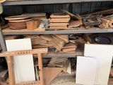 a lot of wood on the shelves in the garage