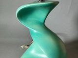 a green lamp that is sitting on a table