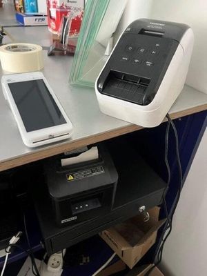a printer and a cell phone sitting on a desk