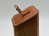 wooden box with a ring on top of it on a white surface