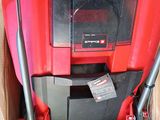 the red and black vacuum cleaner is in a cardboard box