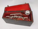 a red box with a silver trumpet inside of it