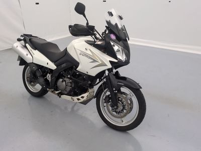 a white and black motorcycle parked in a room