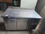 a stainless steel counter with two doors on it