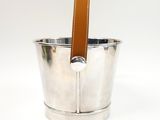 a silver bucket with a leather handle on a white background