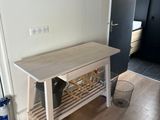 a small table with a wine rack on it in the middle of a room