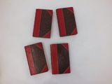 four red and black books sitting on top of a white surface