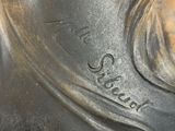 an image of a bronze statue of a woman with a long hair