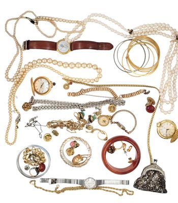 many different types of necklaces and bracelets laid out together