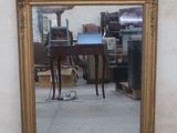 a mirror that is sitting on the floor in front of a wall