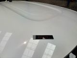 a sticker on the hood of a white car
