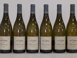 six bottles of wine are lined up in a row on a table
