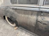 an old car that is sitting on the side of the street