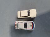 two toy cars that are sitting next to each other on the floor