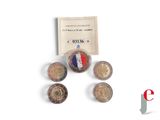 several coins are sitting on a table next to a card