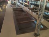 a long counter in a restaurant with a lot of food on it