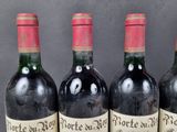 three bottles of red wine are lined up on a table