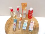many different types of skin care products on a wooden tray