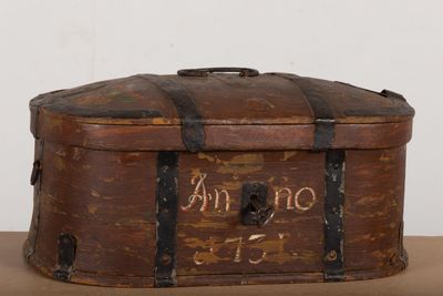 an old suitcase with writing on it sitting on a table