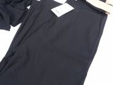 a pair of black pants sitting on top of a white table