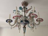 a chandelier hanging from the ceiling in a room