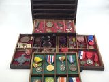 a wooden box filled with medals and other items