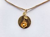 gold plated necklace with a rose and leaf charm on a gold plated chain