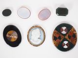 several pieces of art are displayed on a white surface