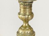 a gold vase that is sitting on a table