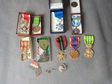 many medals and medals in a box on a table