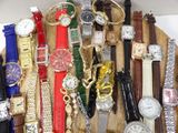 many different types of watches displayed on a wooden board