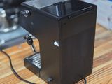a black coffee machine sitting on a wooden counter