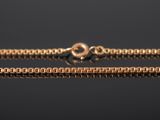 a gold chain on a black background