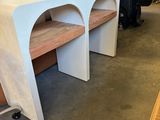 two desks that are sitting in the middle of a room