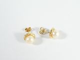a pair of pearl earrings on a white background