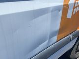an orange and white truck parked on the side of the road