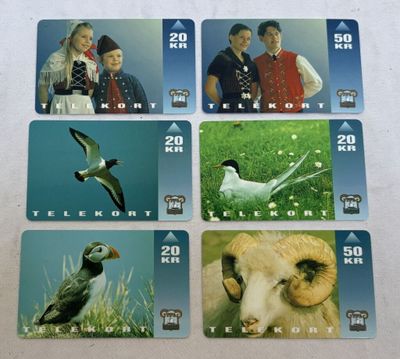 four cards with pictures of people and animals on them on a table