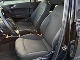 the interior of a car with the door open and the driver ' s seat up