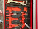 someone is holding a tool box with tools inside of it