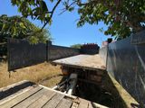 a flatbed truck that is parked in the grass