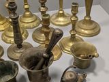 many different types of brass objects on the table