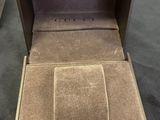 a box with a watch inside of it on the floor