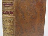 an old book sitting on top of a table next to a white background