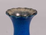 a blue vase that is sitting on a table