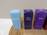 three boxes of blue and purple are sitting on a wooden table
