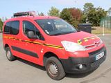 a red van that is parked in a parking lot