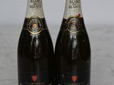 two bottles of champagne sitting on top of a marble counter top