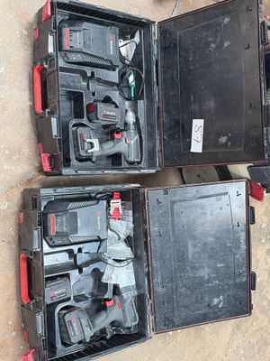 three tools in a case sitting on the ground next to each other