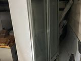 a refrigerator that is sitting in the corner of a room