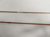 two old fishing rods are hanging on a wall in a room